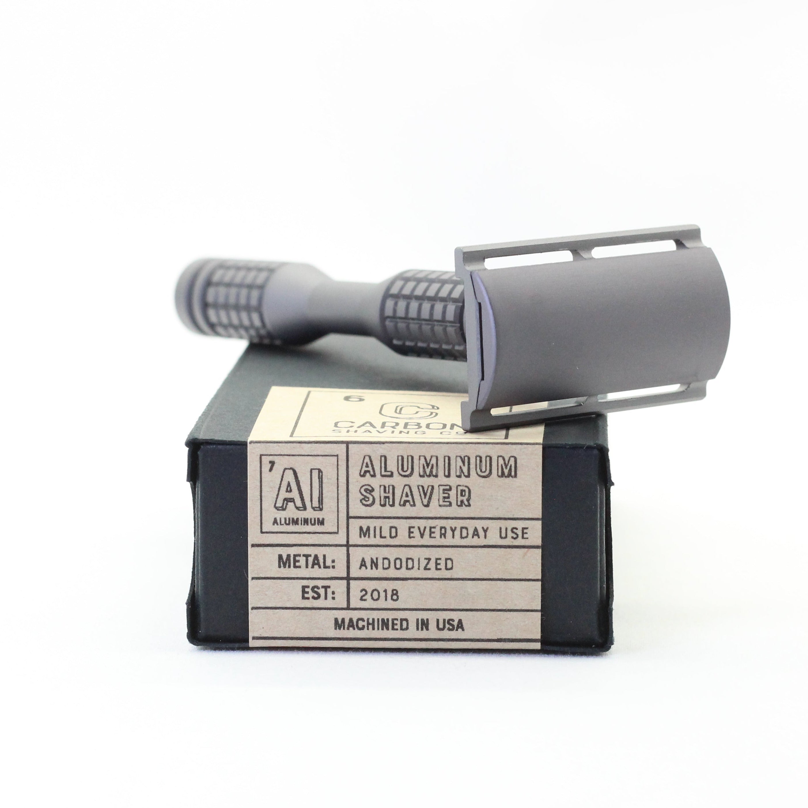 Aluminum shaving razor with packaging on a white background