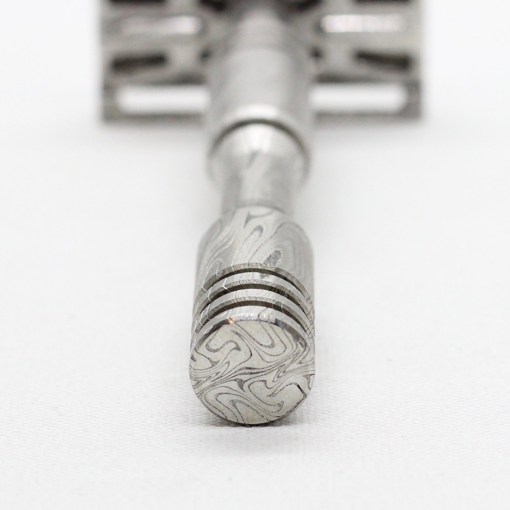 Close up view of handle - Stainless steel Damascus with twist pattern single edge razor a double edge safety razor for wet shaving polished grade 304 and 316 - custom forged in the USA - luxury high end safety razor to reduce ingrown hairs and irritation - for a smooth shave