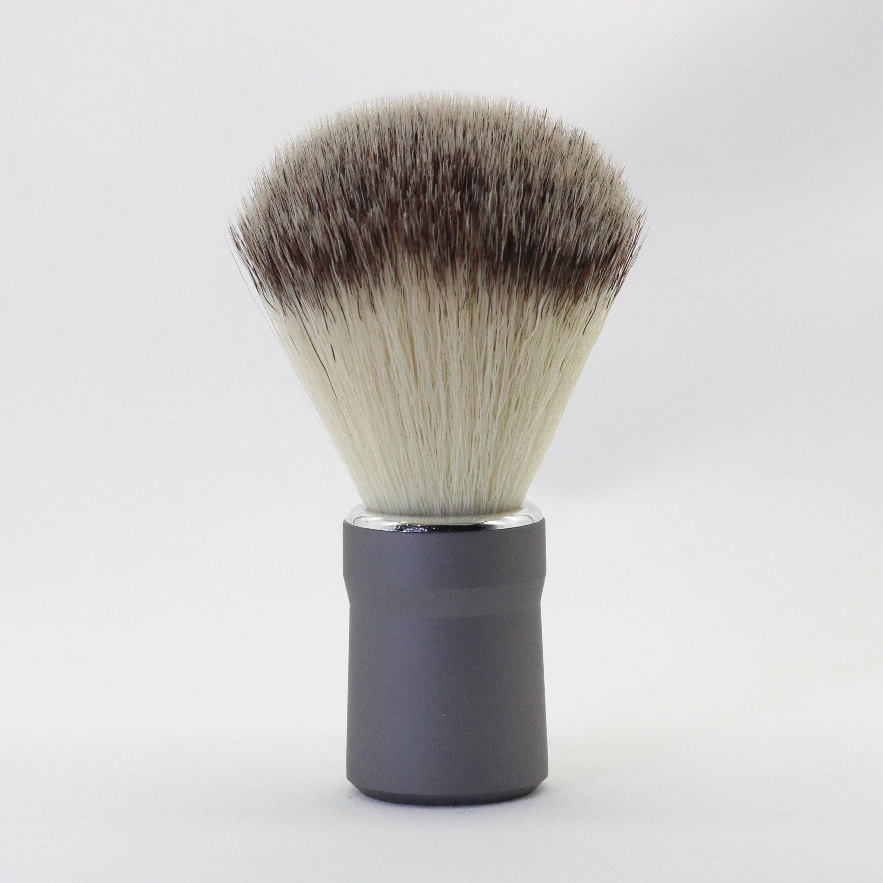Shaving brush with black and white bristles on a white background