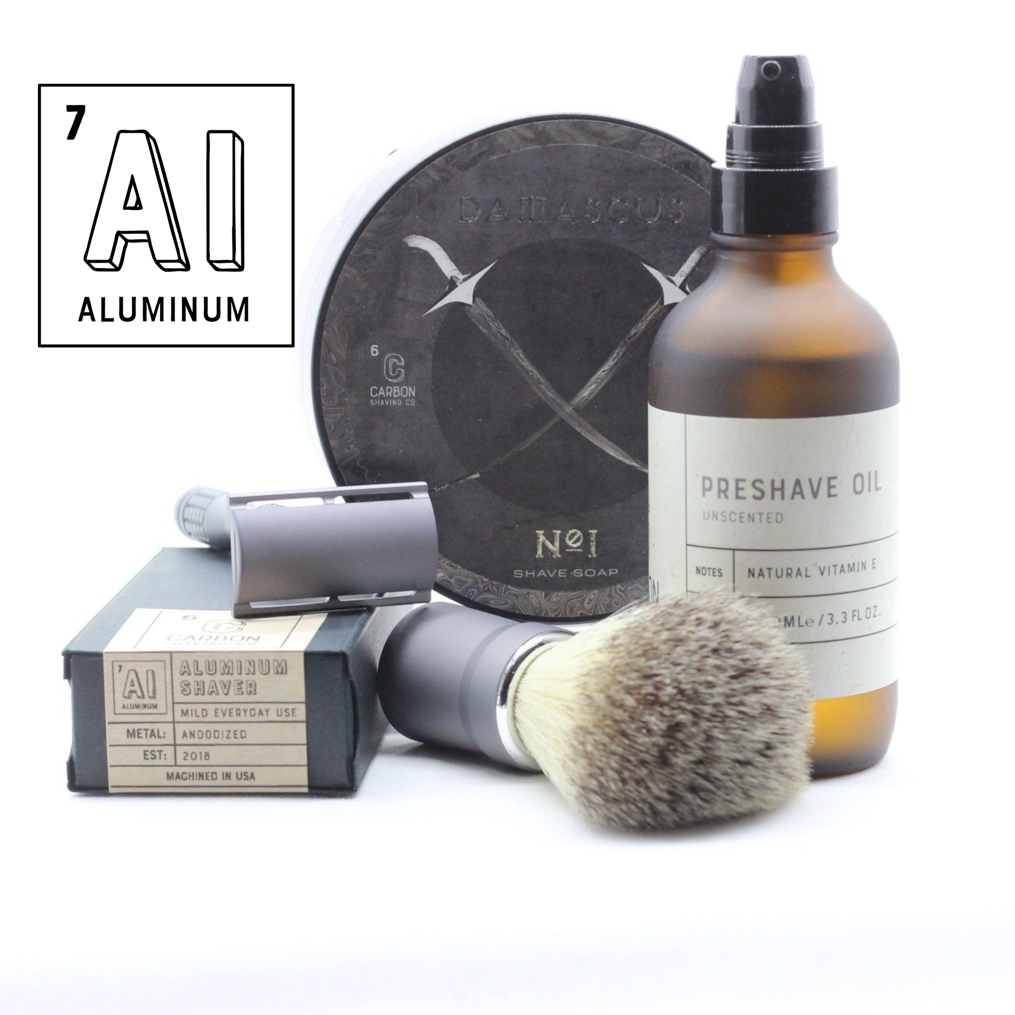 Set of shaving products including a bottle, brush, and packaging on a white background