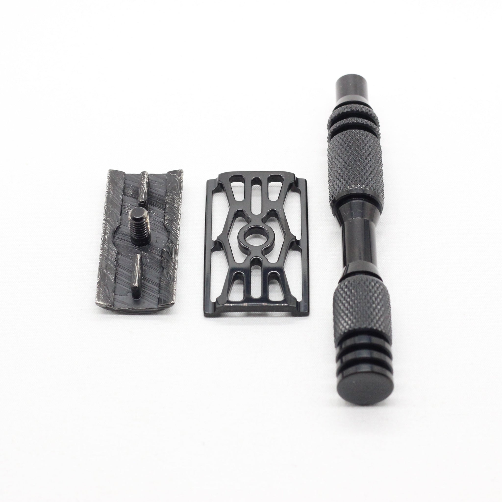 Three black metal components on a white background