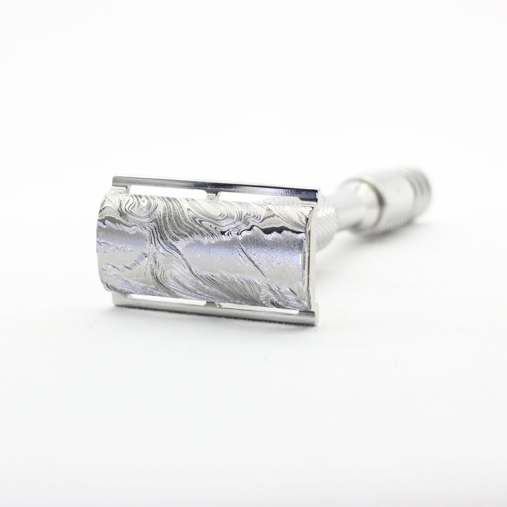 Silver safety razor on a white background