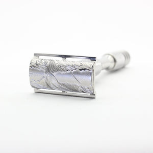 Silver safety razor on a white background