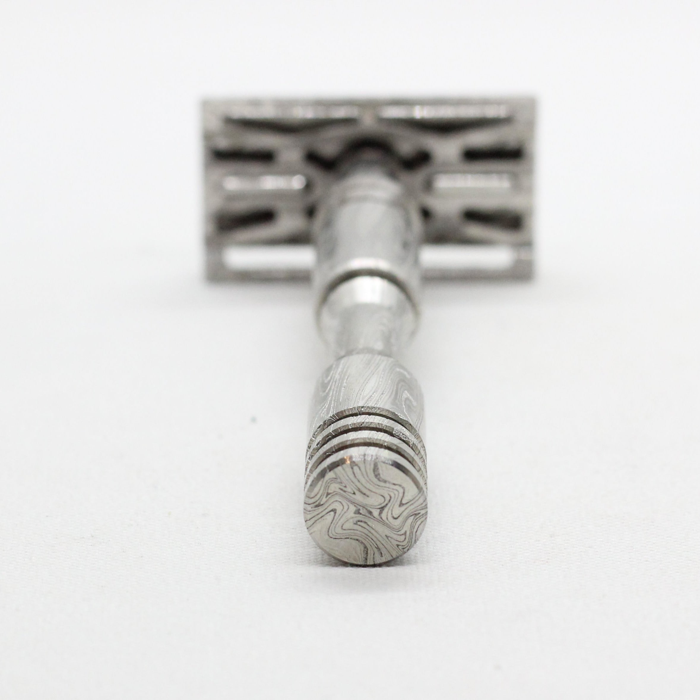 Bottom of handle view - Stainless steel Damascus with twist pattern single edge razor a double edge safety razor for wet shaving polished grade 304 and 316 - custom forged in the USA - luxury high end safety razor to reduce ingrown hairs and irritation - for a smooth shave