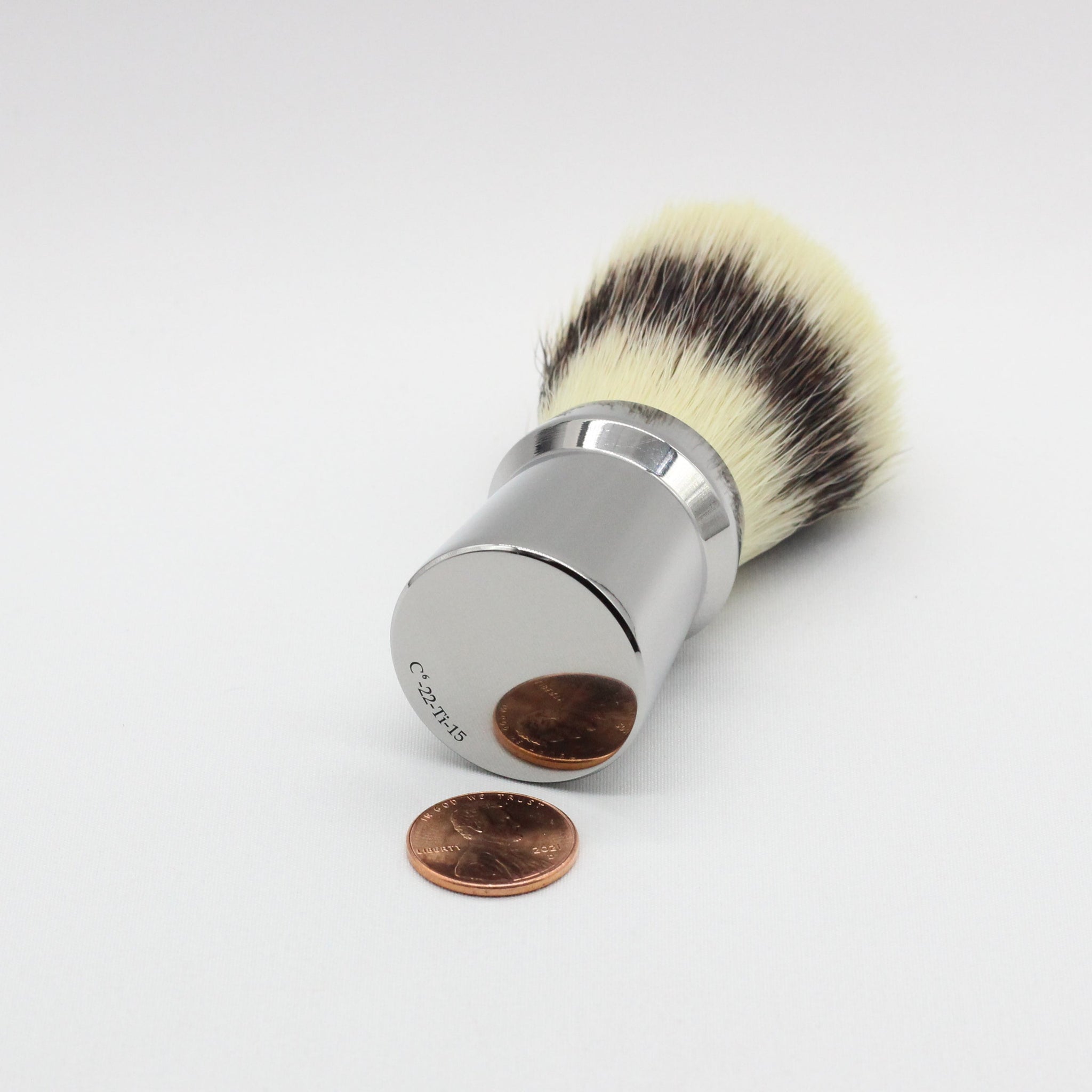 Coin reflection - Titanium Shaving brush - high polish finish to reduce places where dirt and bacteria can collect - Used to lift hairs and soften skin while shaving. Essential part of a grooming kit 